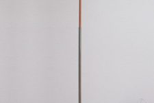 22 a minimalist floor lamp with a concrete base, abrass leg and a bulb, no lampshade