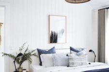 22 a navy blanket and pillows for adding a touch of color to the neutral space