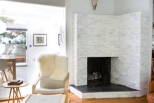 23 a cozy fireplace nook with a leather chair and a footrest plus a cowhide rug for reading