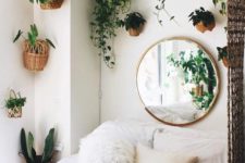 23 turn your bedroom into a jungle with lots of potted greenery on the walls around the bed