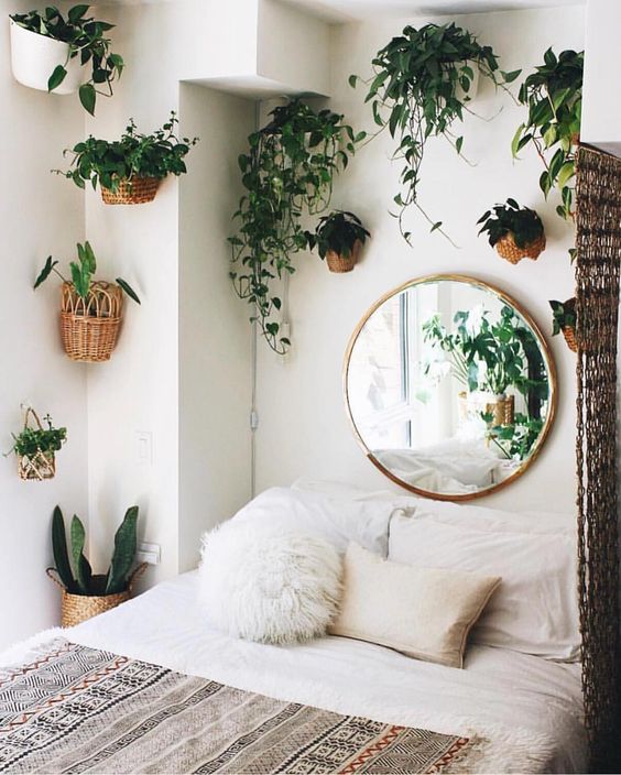 turn your bedroom into a jungle with lots of potted greenery on the walls around the bed