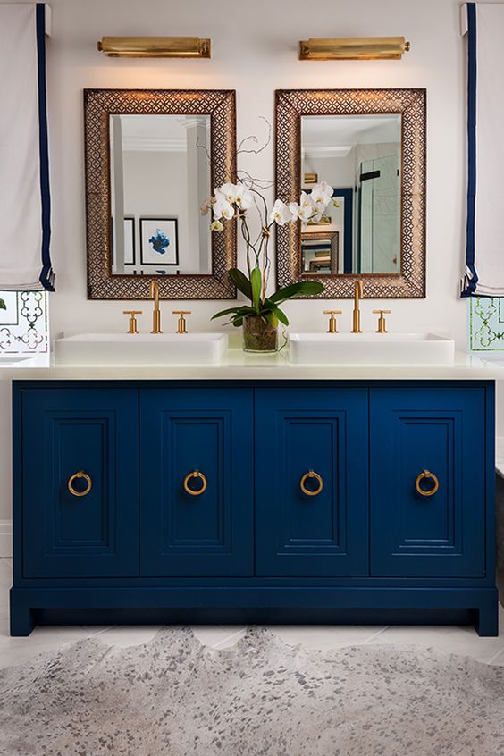 a chic navy bathroom vanity with ring pulls in brass adds an elegant feel to the bathroom