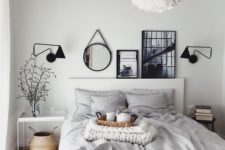 24 a light grey bedroom enlivened with some artworks, a mirror and sconces in black for depth