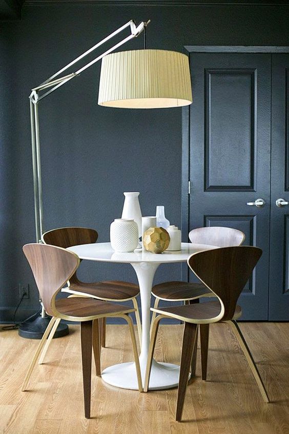 a statement flooor lamp with a metal leg and a large faric lampshade to accent the table
