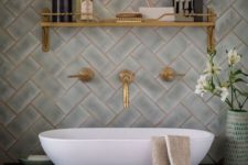 24 make your bathroom wow with pattern clad tiles and brass grout plus brass fixtures and shelves