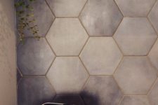 25 matte grey hexagon tiles spruced up with gold grout to give it an elegant touch