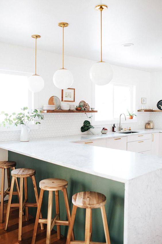 white cabinets and a green kitchen island are united with the same countertops for a continuous look