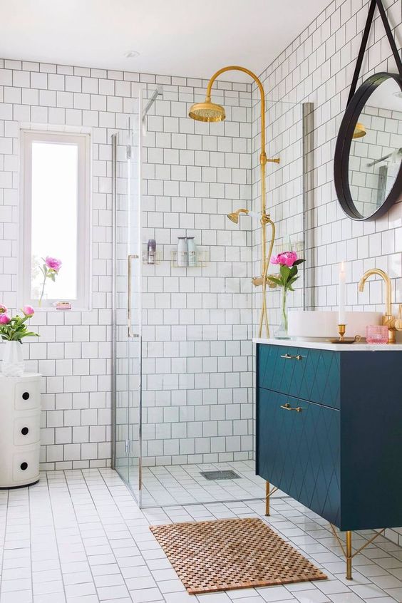 a chic geometric navy vanity with brass touches looks wow and bold and will add chic to the space