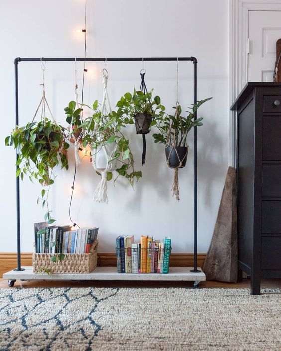 use your old clothes rack to display some cool potted plants in an unusual way