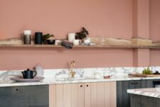 a salmon pink kitchen with dark-stained cabinets, a white countertops, a living edge ledge used for decor and storage