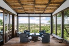 01 This gorgeous house with extensive glazing offers amazing views and a contemporary meets rustic design