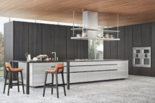 02 The kitchen is done in dark and light grey, there is solid wood and stainless steel that create a contrast and a modern feel