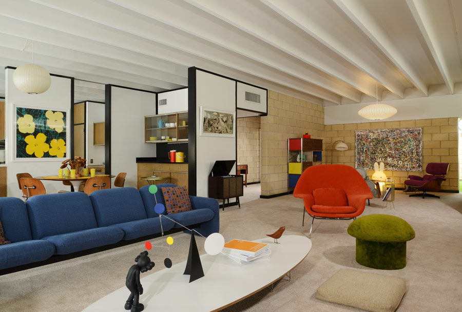 The living space is a open layout with bright furniture and accessories and comfy sitting spaces