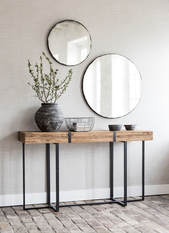 a duo of round mirrors in simple frames for a boho chic entryway