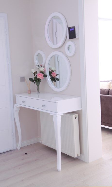 a chic vintage-inspired makeup nook done with a half table and several mirrors