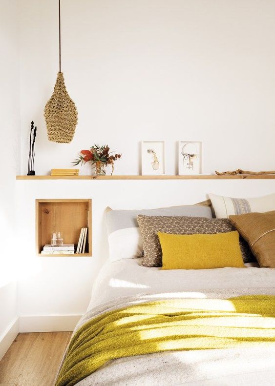 a mustard pillow and blanket make a bold colorful statement and add cheerfulness to the space
