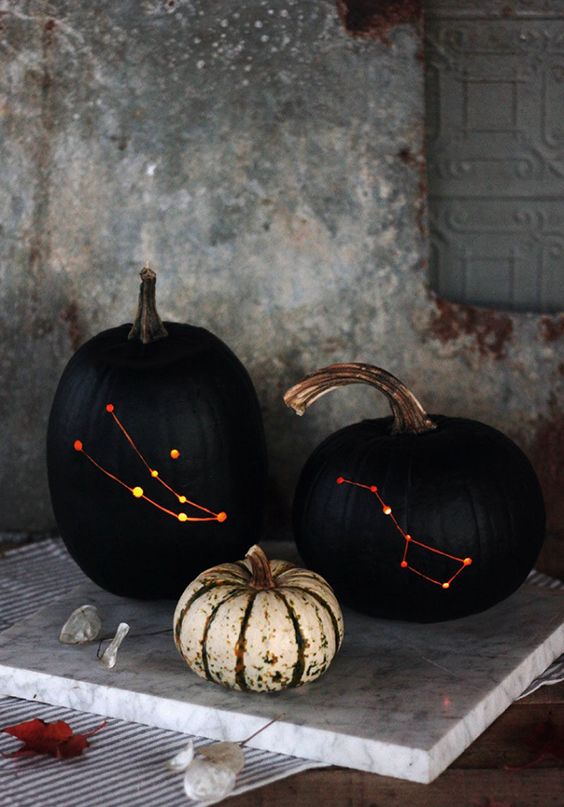 stylish black drilled pumpkins with lights inside instead of usual spooky carved ones