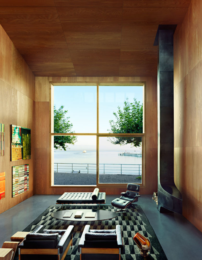 The living room is done with a giant window that lets enjoy the views and fills the space with light