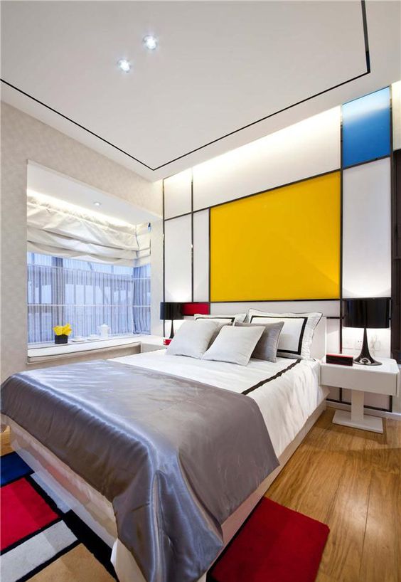 a color block headboard wall and a matching rug is a great idea to fill your bedroom with color in a stylish way