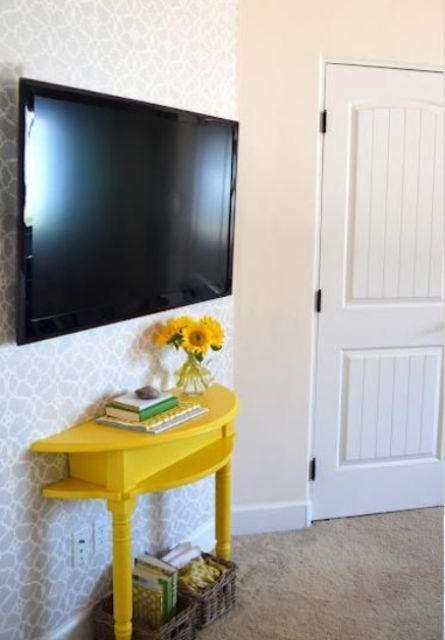 a comfy TV console of a half cut table painted bold yellow will provide some storage without taking much space