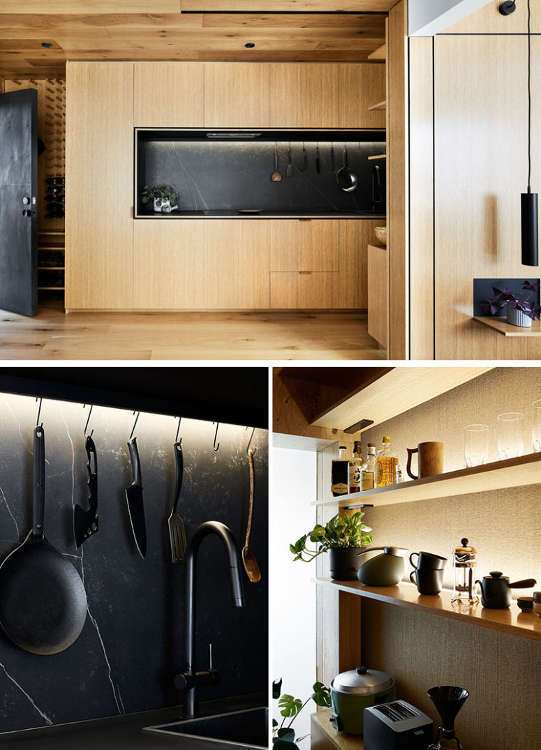 The kitchen is a light-colored wood unit with black marble for a contrast