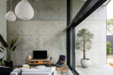 05 The living space is done in grey shades with black, with light-colored plywood