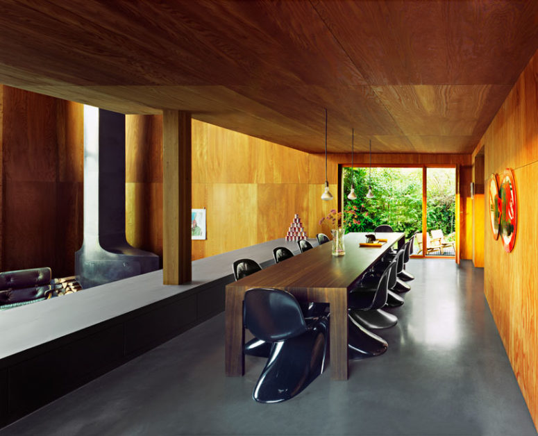 There's a space divider to divide the living room and the dining space with stylish curved chairs and a plywood table