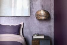05 a bold color blocked bedroom with a bright purple wall and lavender plaster ones for an enchanting look