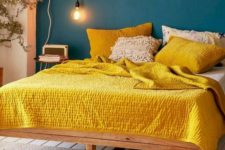 05 a teal wall and bright yellow bedding create a super bold contrast and a wow look
