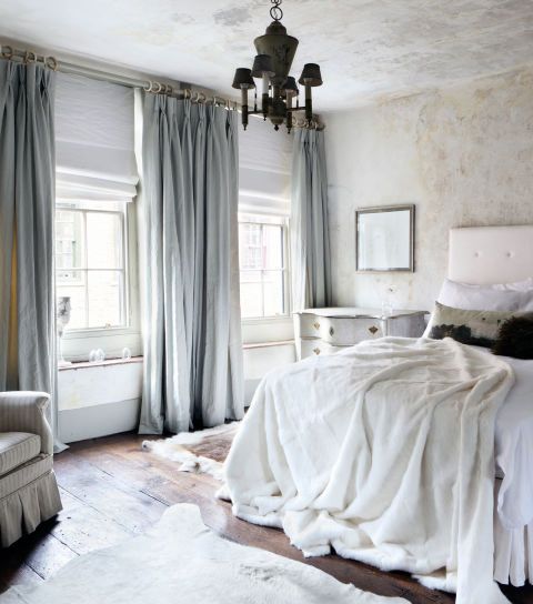 heavy grey silk curtains match the bedroom decor and make the space warmer keeping the cold away