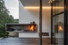 an outdoor open fireplace is a stylish touch to the deck