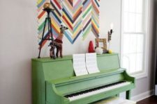 06 a grass green piano and a bold chevron artwork right on the wall to add color and interest to the space