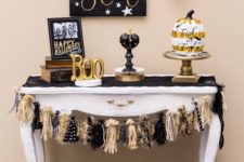 06 a spooktacular console with fake pumpkins, a tassel garland, a sign and gold letters