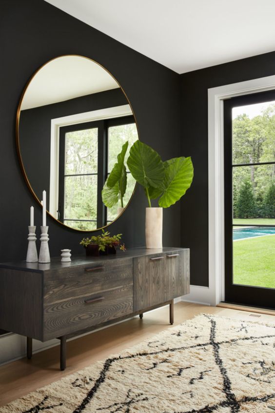 a statement oversized mirror is another cool idea to fill in a blank wall