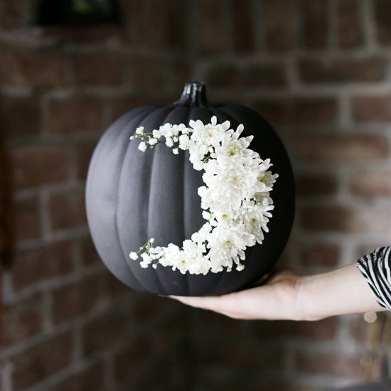 go for creative art decorating your matte black pumpkin with white blooms like that