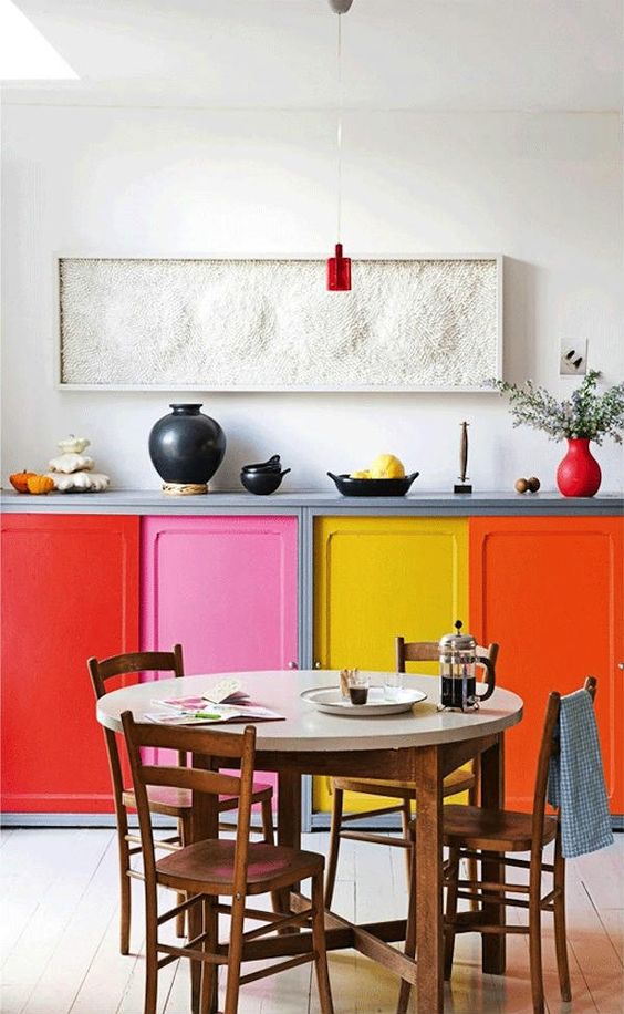 jazz up even the tiniest kitchen with bright cabinets, each of a different color and shade