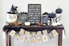 07 a console with black and white spiderweb, lots of pumpkins, signs and branches