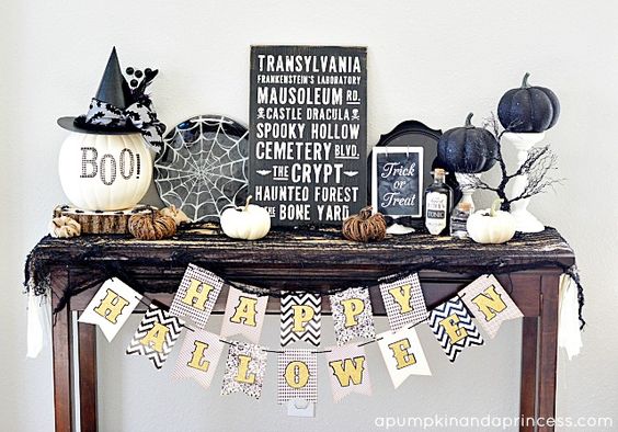 a console with black and white spiderweb, lots of pumpkins, signs and branches
