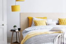 07 yellow printed lampshades echo with pillows and a blanket and add color to the neutral space