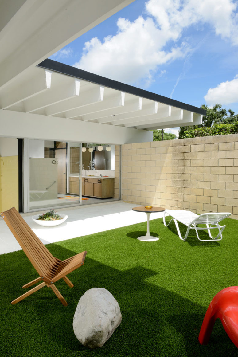 The outdoor space includes some loungers, sitting zones and a perfect lawn