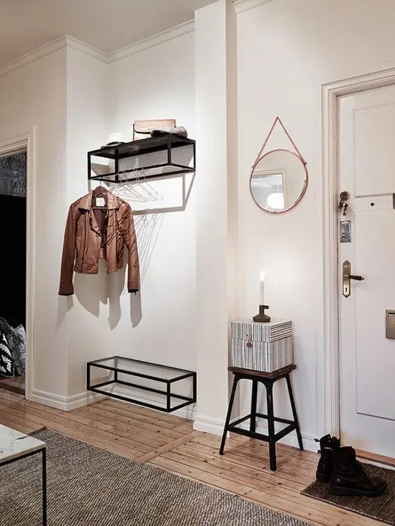 a coat rack features a holder for clothes hangers, which has an airy look and accommodates many items
