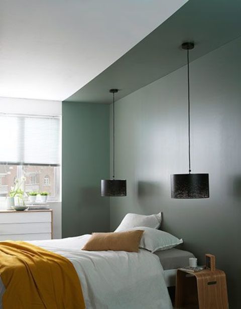 a dark green bedroom niche in a neutral bedroom brings color and makes a statement