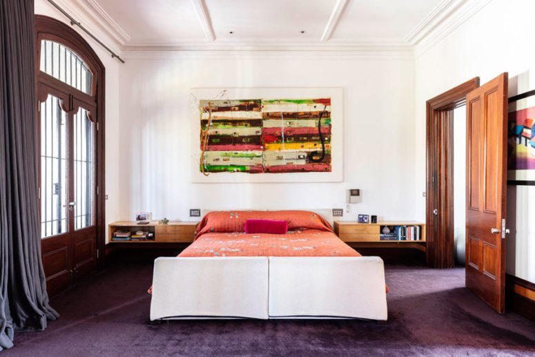 The guest bedroom is bright and colorful, in coral, plum, orange and green and it's more private