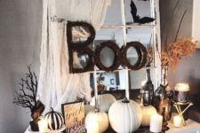 09 a Halloween console in black and white, with fake pumpkins, candles, lace and twig letters plus a window frame