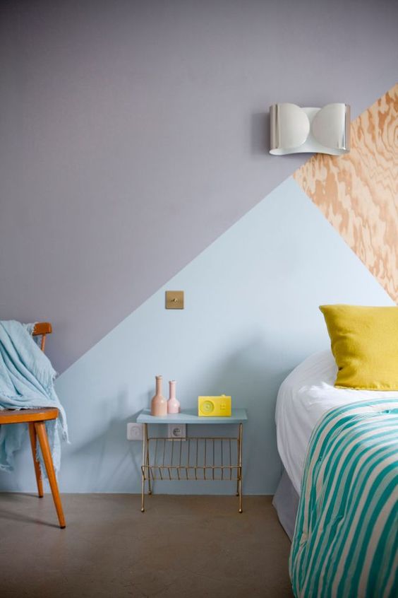 a geometric color block wall in grey, light blue and plywood for a chic and stylish bedroom