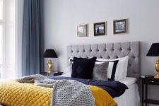 09 a grey and blue bedroom spruced up with a yellow blanket for a bright and cheerful look