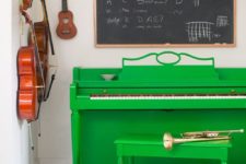 09 an emerald piano and stool, a chalkboard for making notes and other musical instruments for a music-loving person