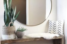 09 an oversized round mirror in a brass frame is a cool modern idea suitable for boho or contemporary spaces