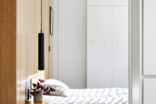 10 The bedroom shows off a wooden headboard and some hidden storage with hooks