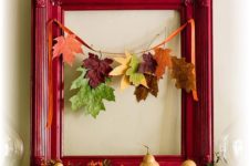 mantel decor with a red frame and a fall garland